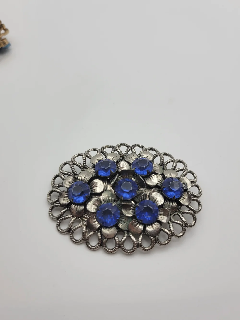 Vintage-Inspired Silver Floral Brooch with Blue Crystal Accents
